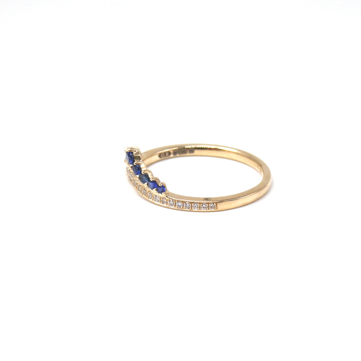 A New ring, curved diamond band with graduating sapphires.