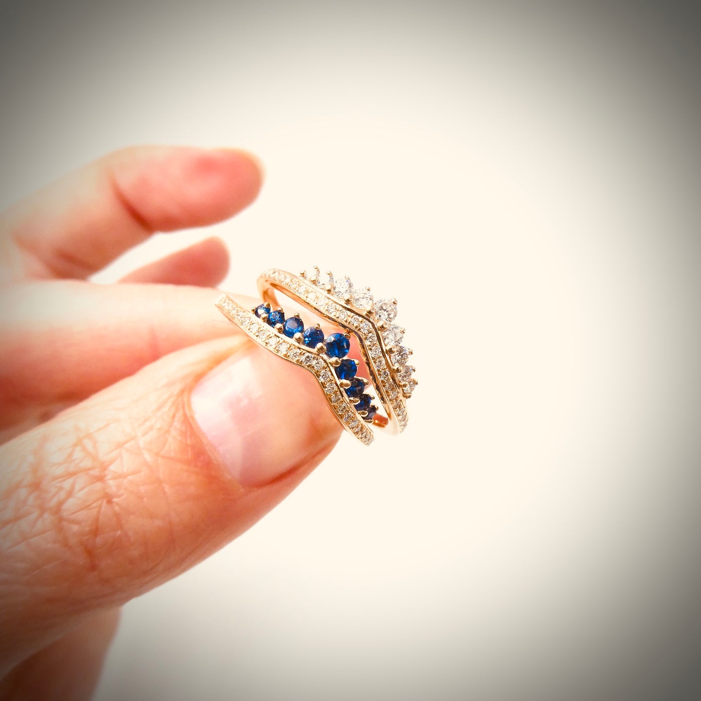 A New ring, curved diamond band with graduating sapphires.
