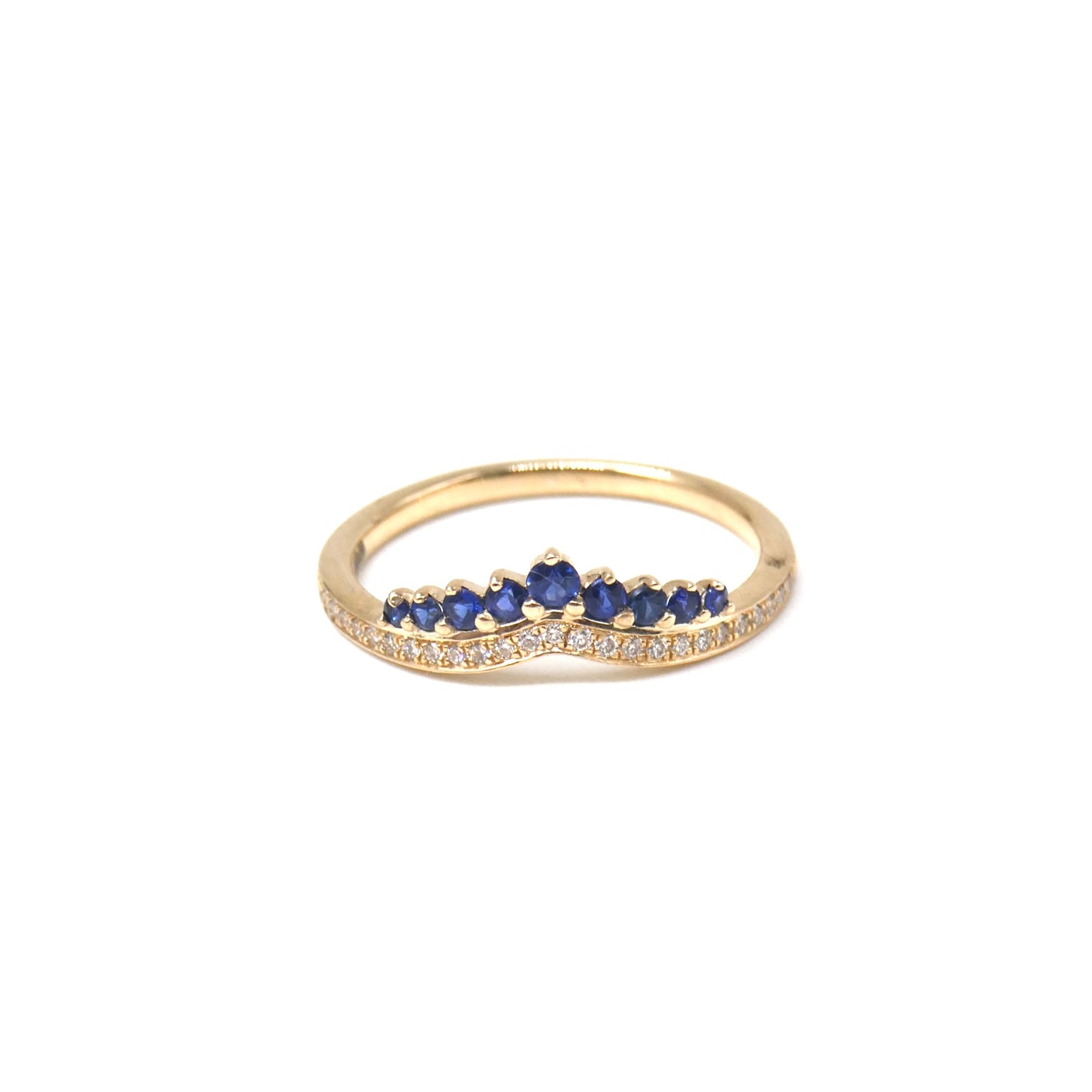 A New ring, curved diamond band with graduating sapphires.