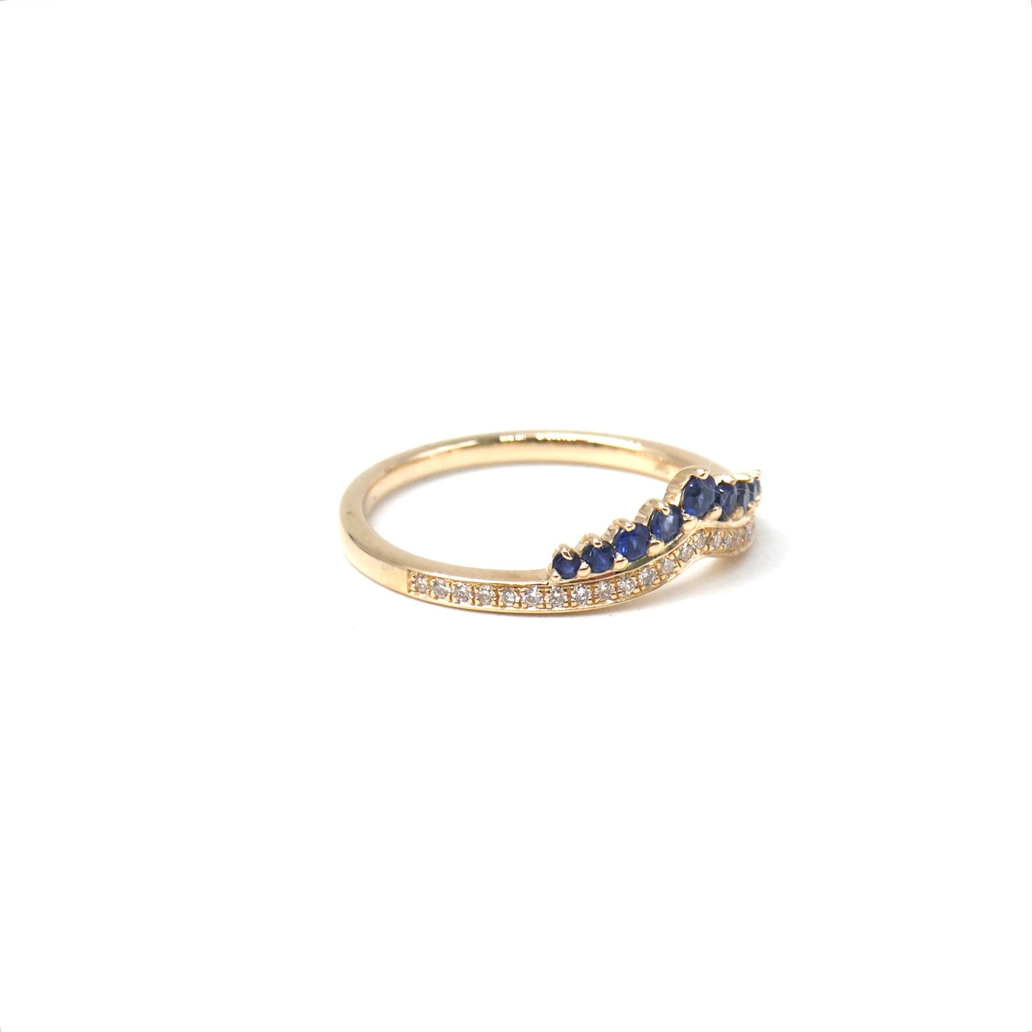 A New ring, curved diamond band with graduating sapphires.