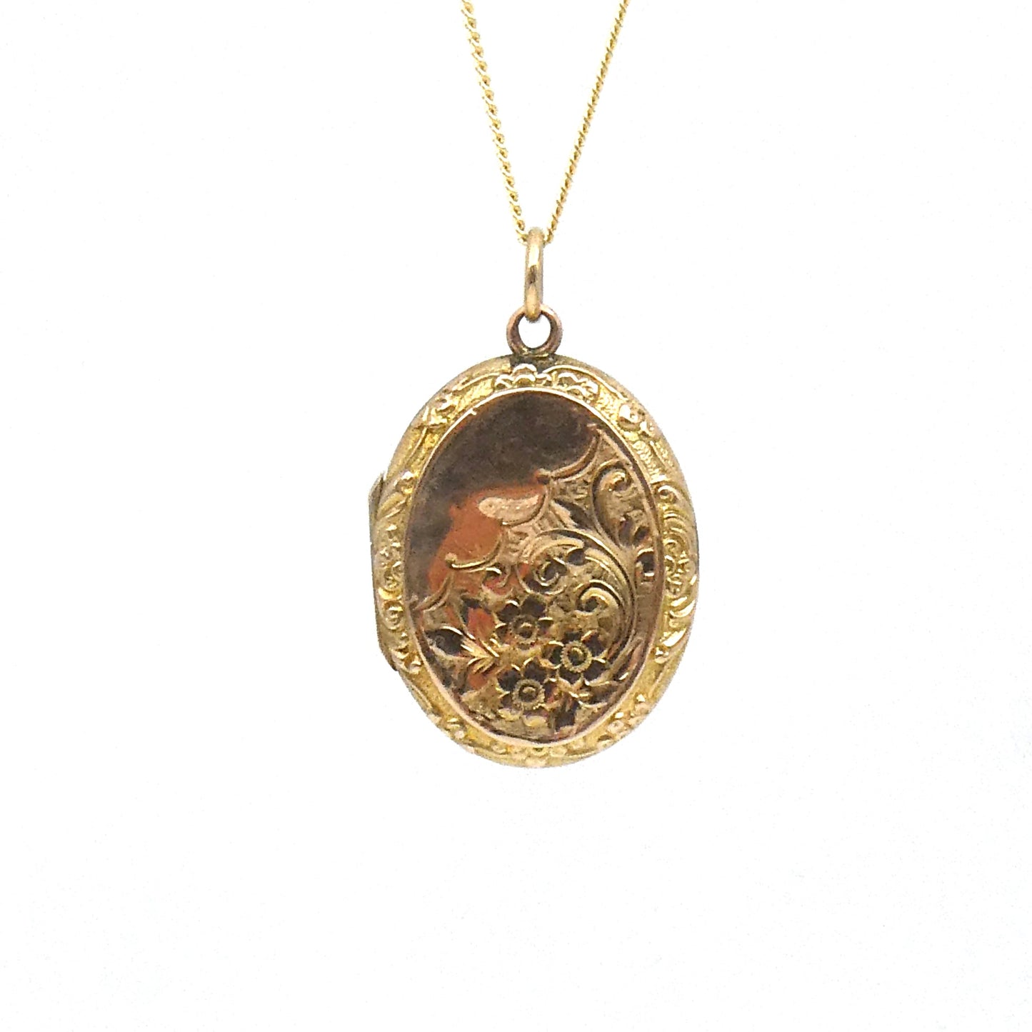 Engraved oval locket, antique gold back and front locket on a 9kt gold chain.