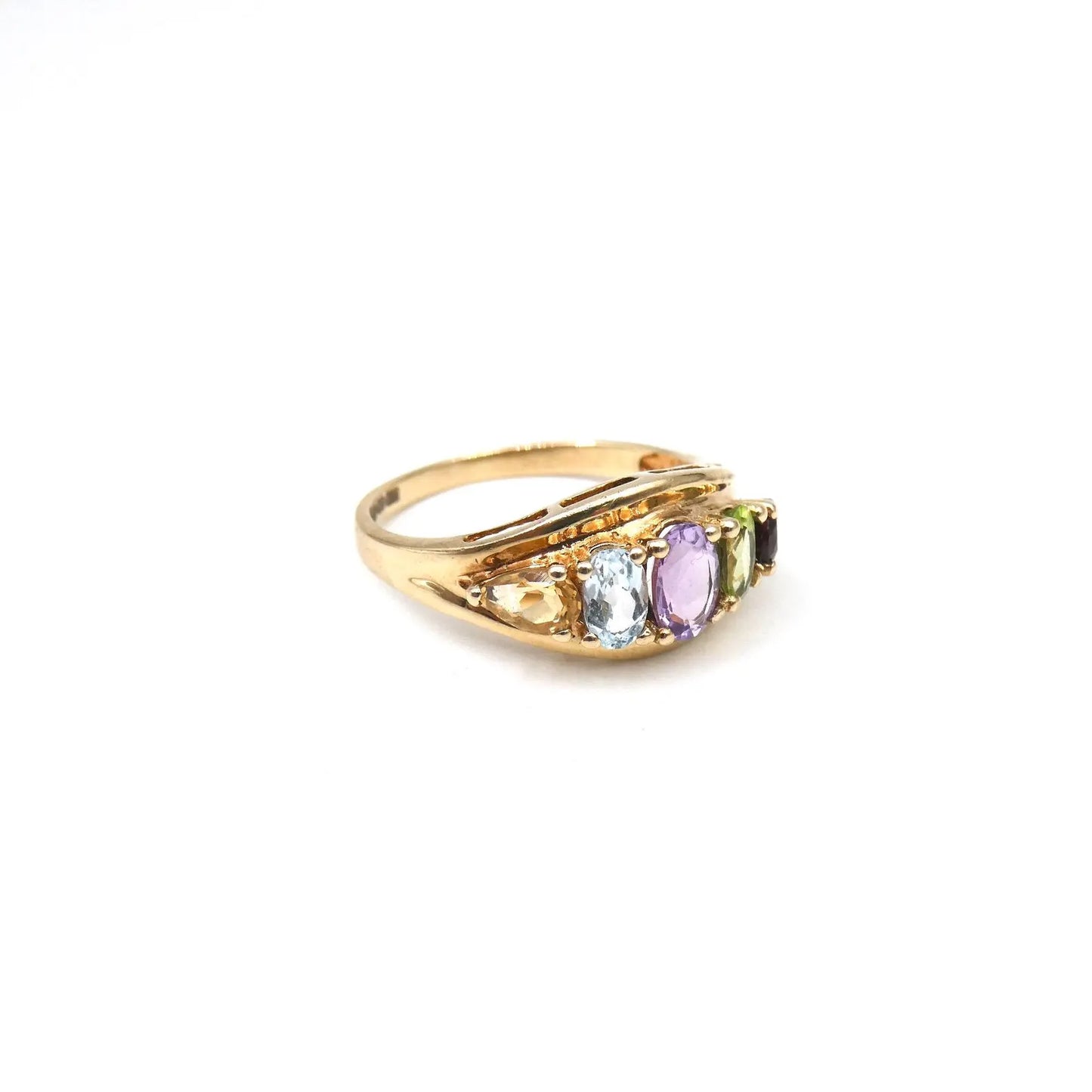 An unusual gold ring set with gemstones framed by the 9kt gold setting,