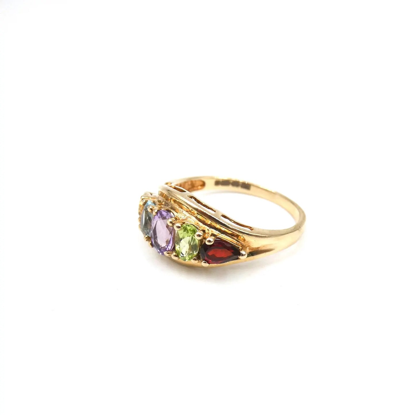 An unusual gold ring set with gemstones framed by the 9kt gold setting,