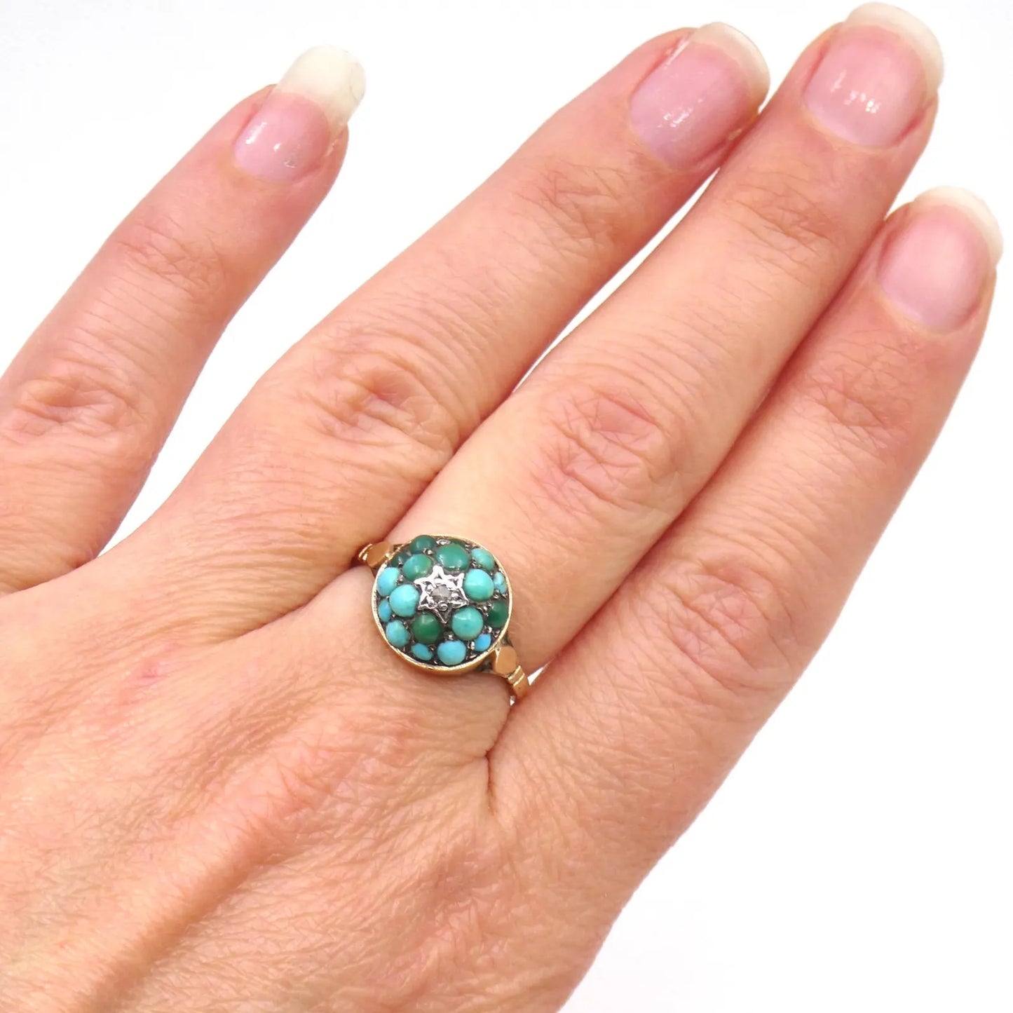 An antique turquoise bombe ring set with a star in the centre with a little diamond.
