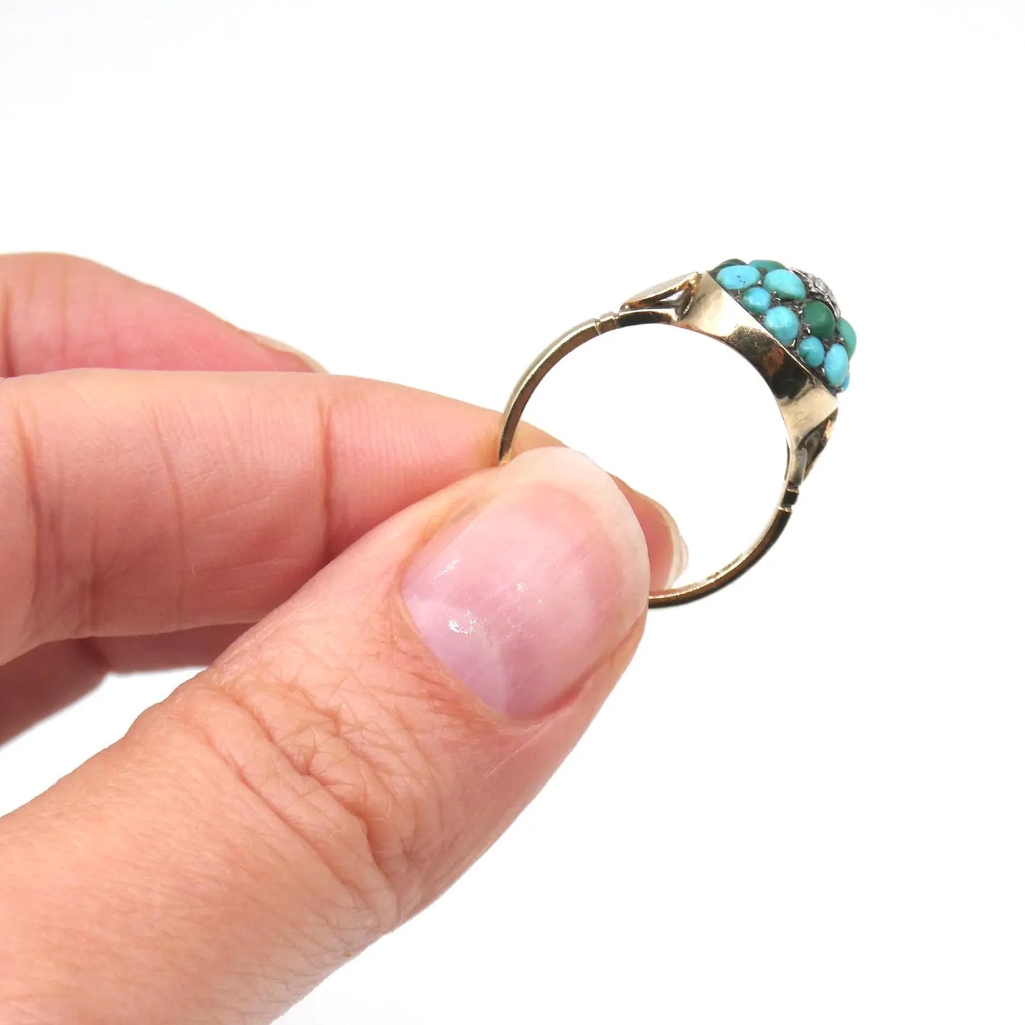 An antique turquoise bombe ring set with a star in the centre with a little diamond.