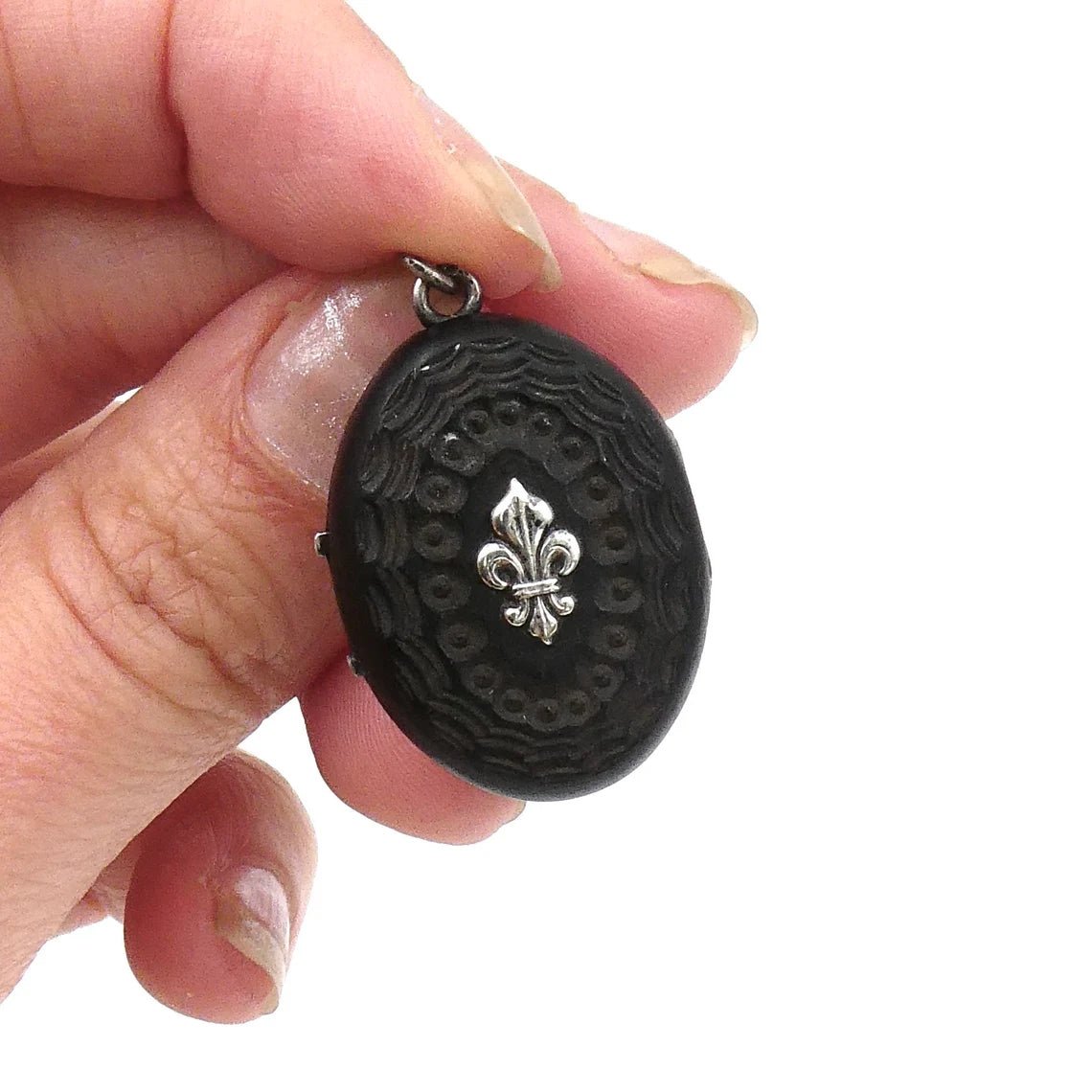 A unique carved black wooden locket with silver fleur de lis and initals in relief. - Collected