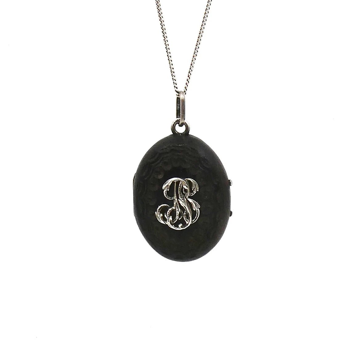 A unique carved black wooden locket with silver fleur de lis and initals in relief. - Collected