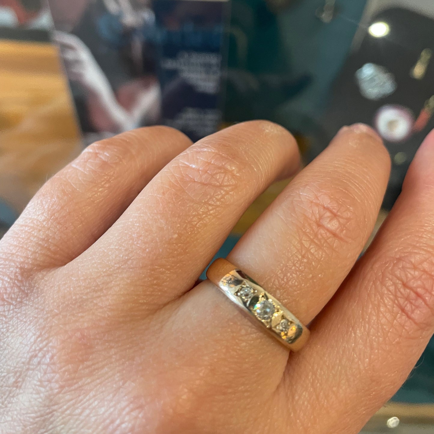 A heavy 9kt gold gypsy trilogy ring, set with three Moisanites.