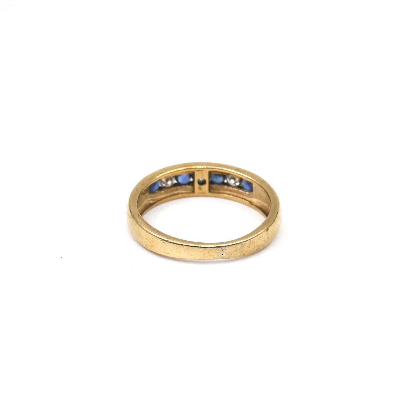 Fine sapphire band, an eternity style ring set with four sapphires alternated with crystals.