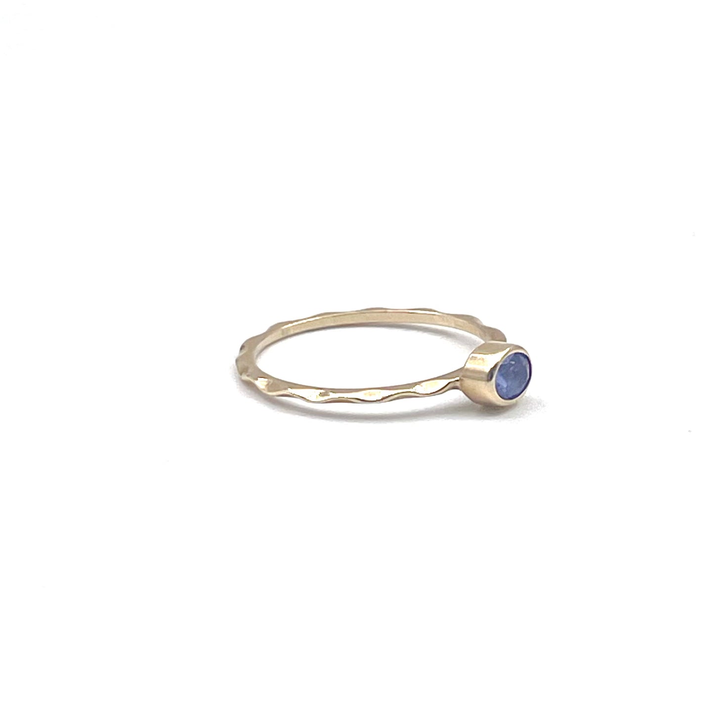 Tanzanite stacking ring on a 9kt wave band, preowned.