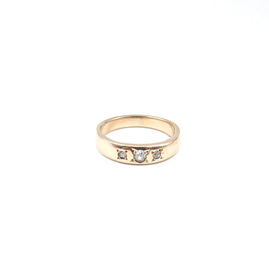 A heavy 9kt gold gypsy trilogy ring, set with three Moisanites.