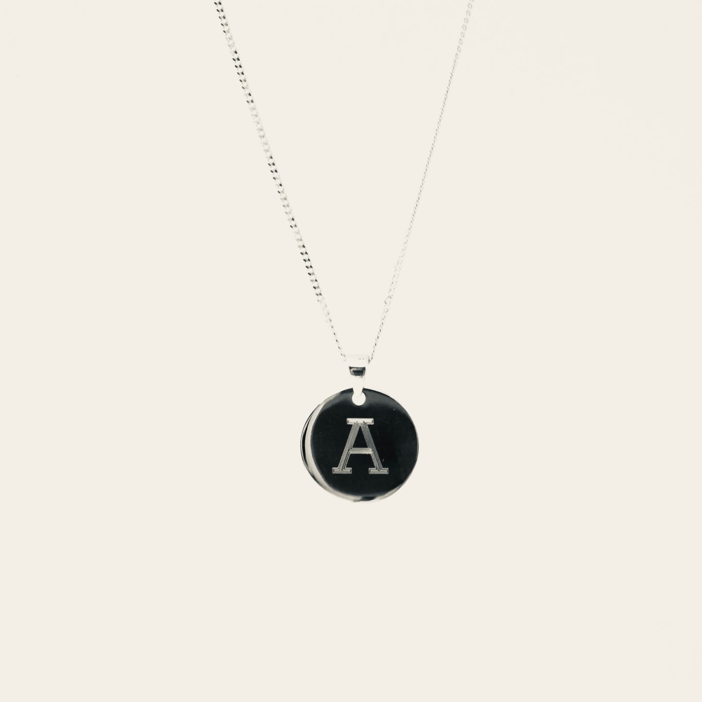 A Gold Disc Pendant with a 9kt gold and diamond star charm, diamond is the April Birthstone.