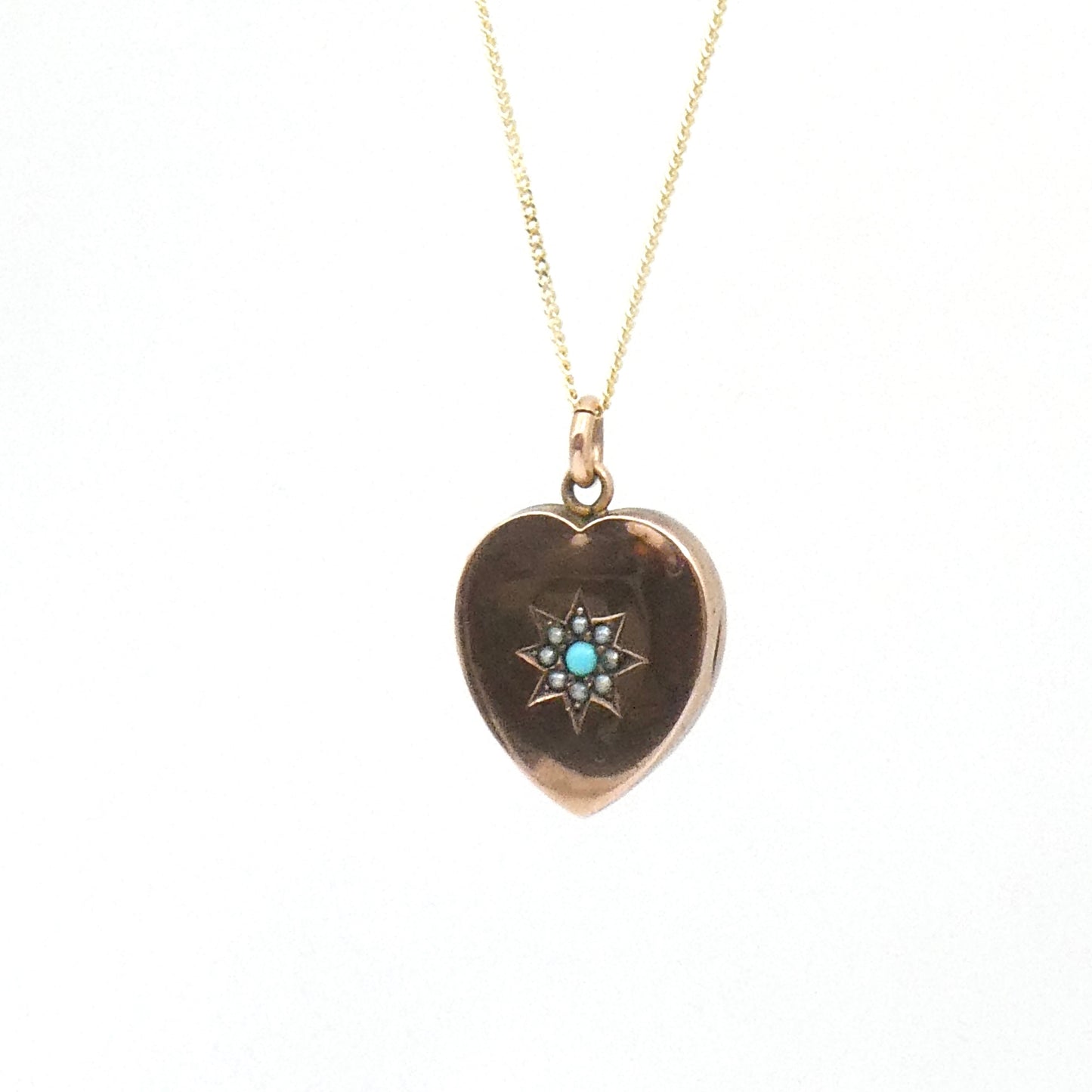 Antique Heart Locket and a turquoise and split pearl star set motif, on a 9kt gold chain.