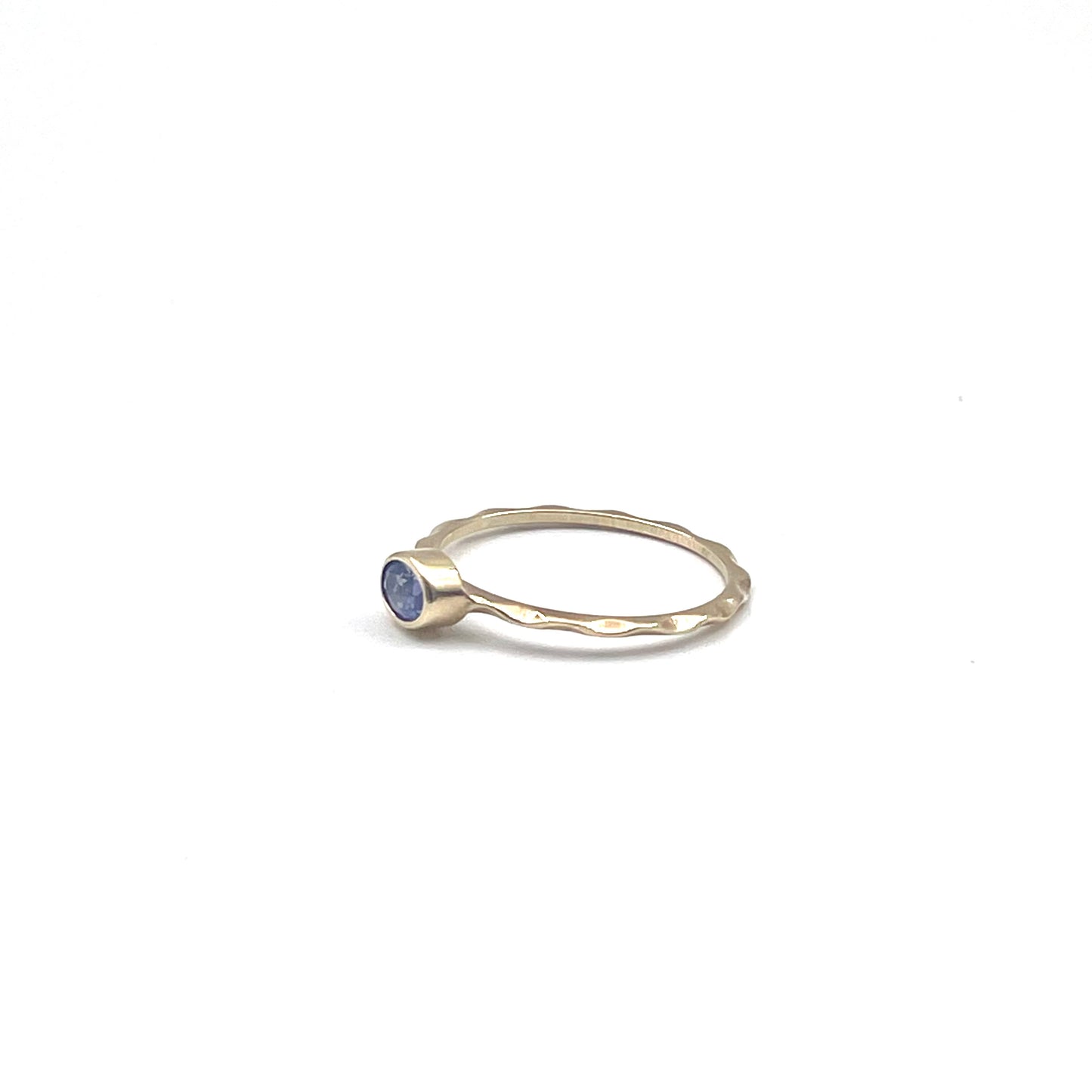 Tanzanite stacking ring on a 9kt wave band, preowned.
