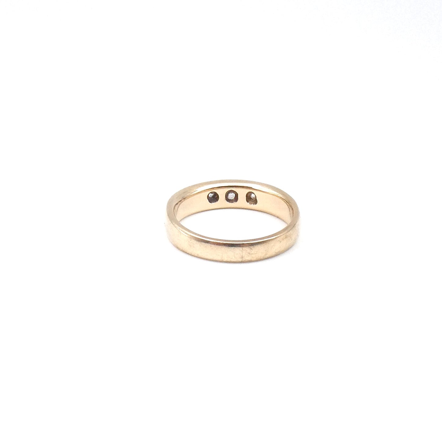 A heavy 9kt gold gypsy trilogy ring, set with three Moisanites.