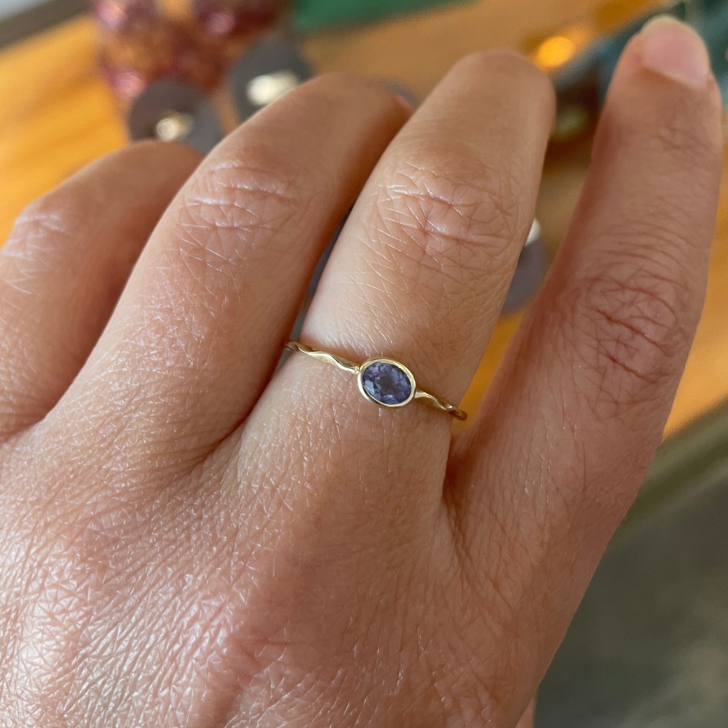 Tanzanite stacking ring on a 9kt wave band, preowned.