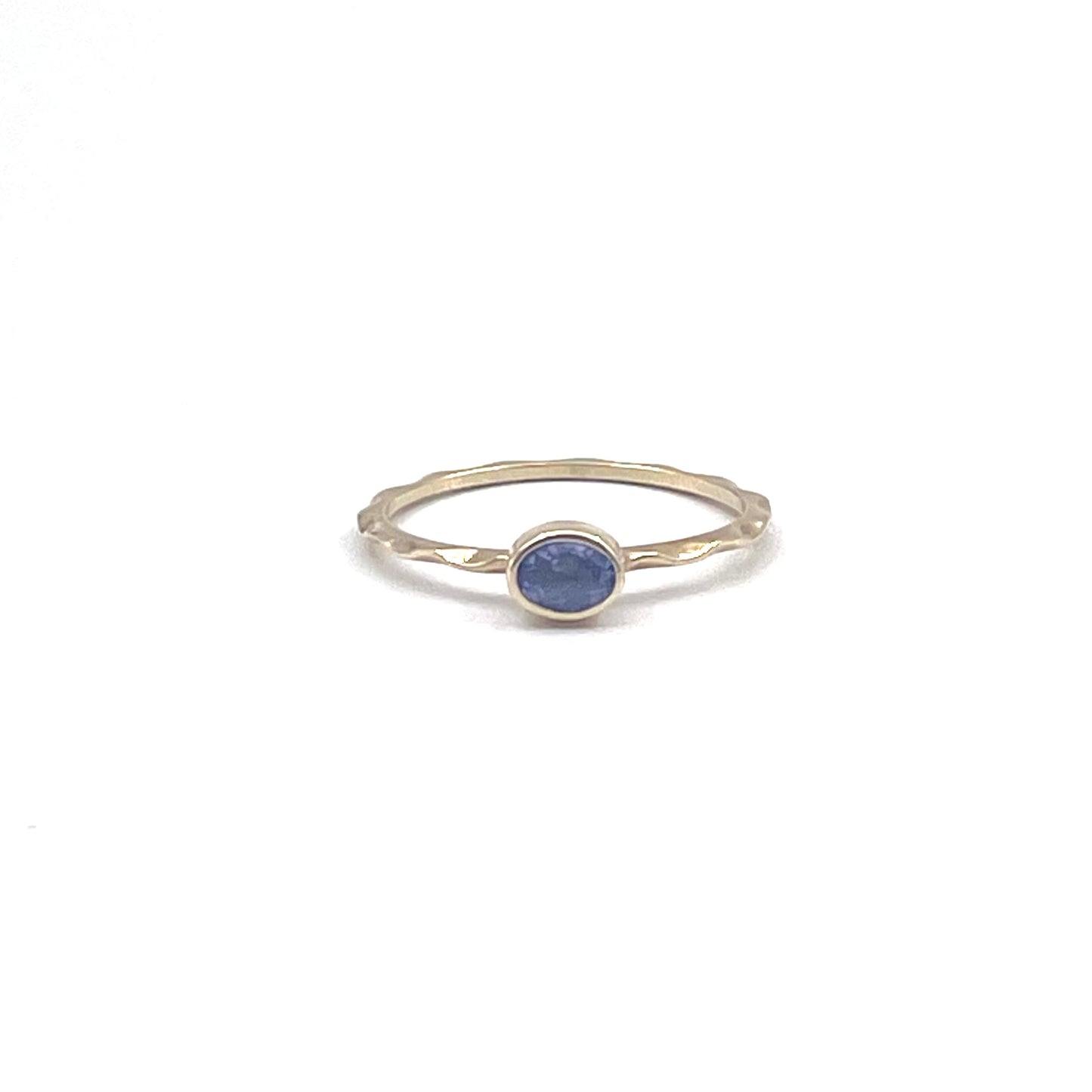 Tanzanite stacking ring on a 9kt wave band, preowned.