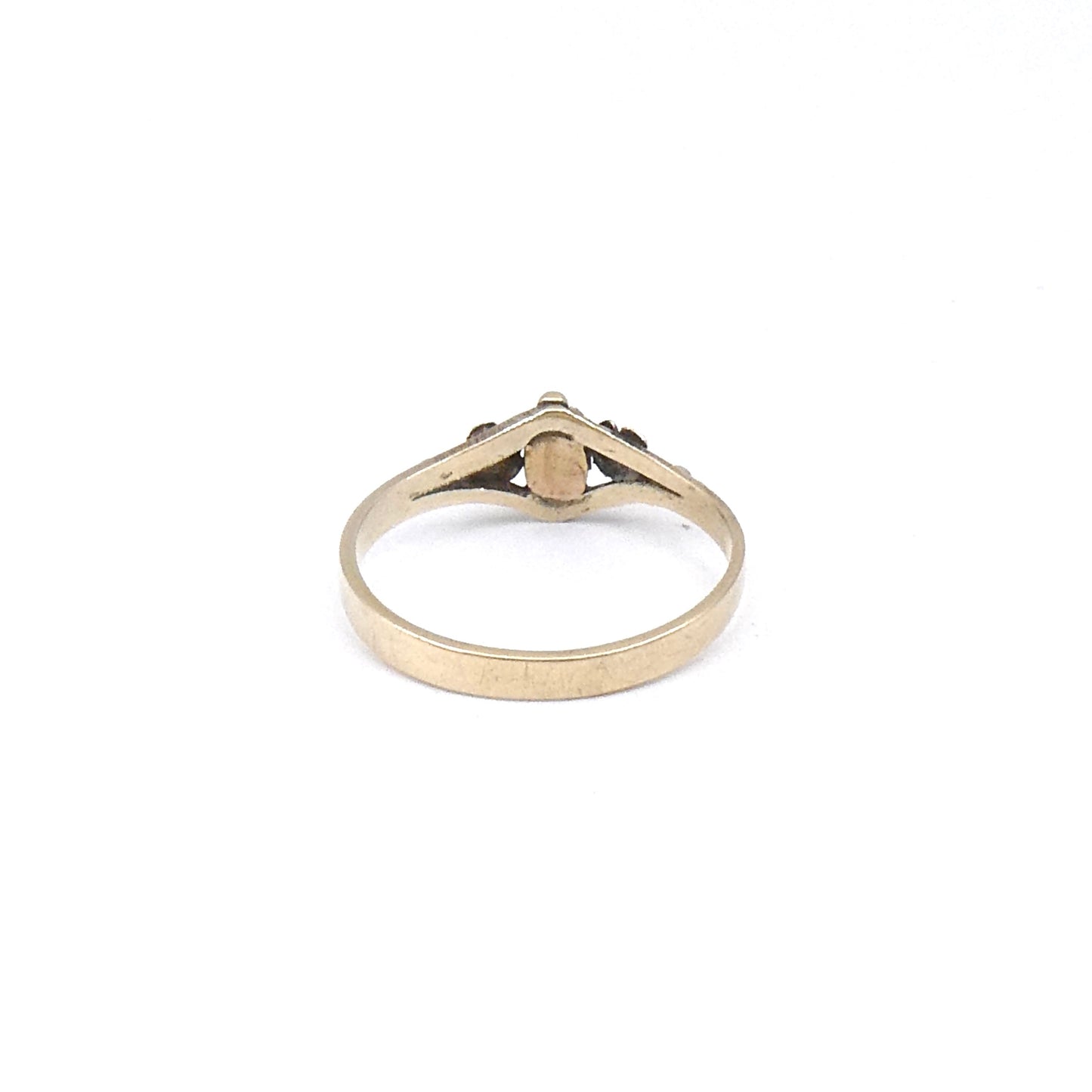 Antique ring with etched flowers and a small rectangular emerald.