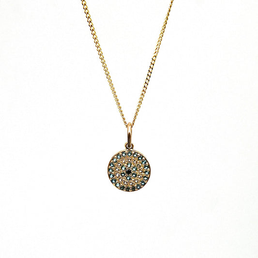 A 9kt gold Evil Eye disc with gemstones.