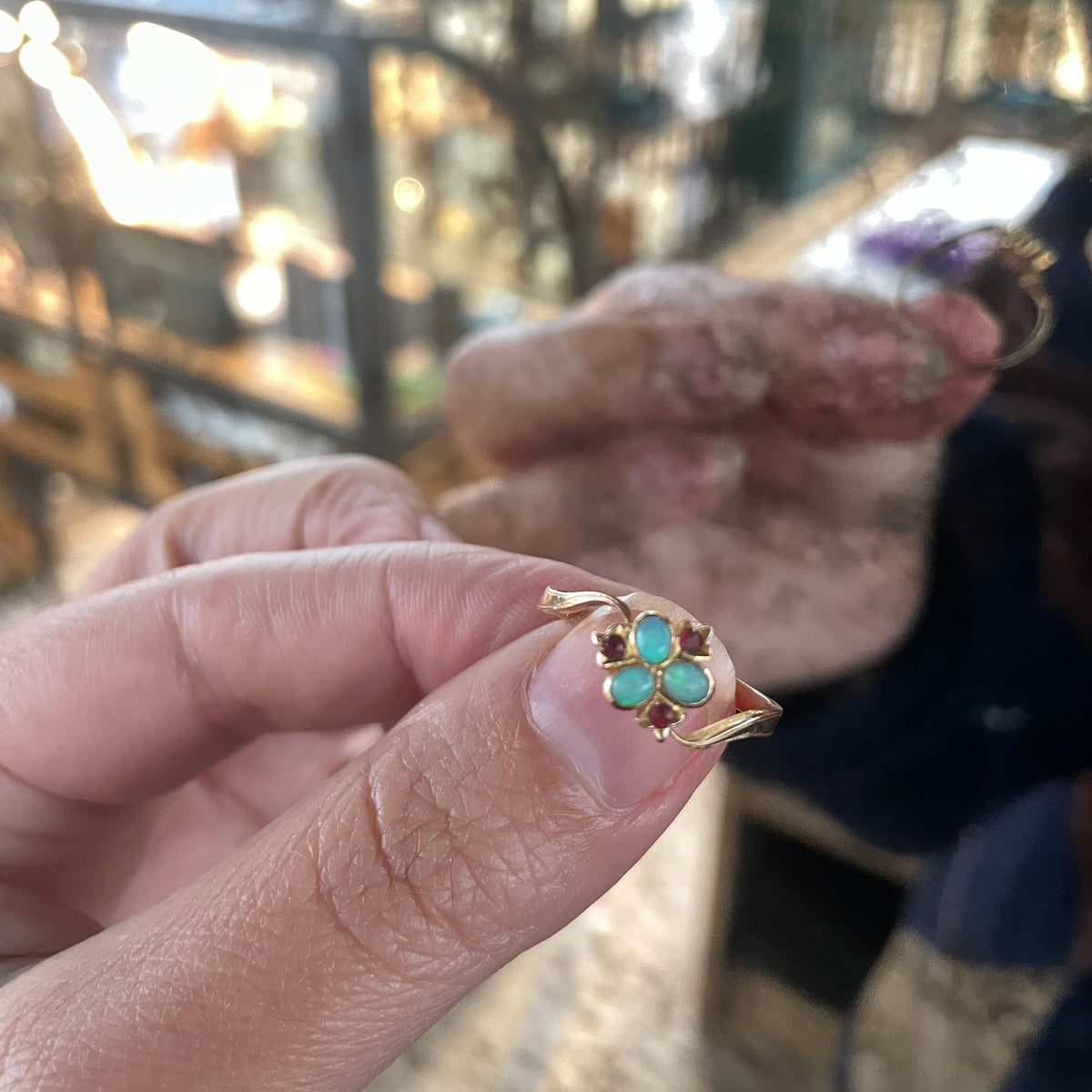 Opal flower ring set with vibrant opals and rubies, 18kt gold.