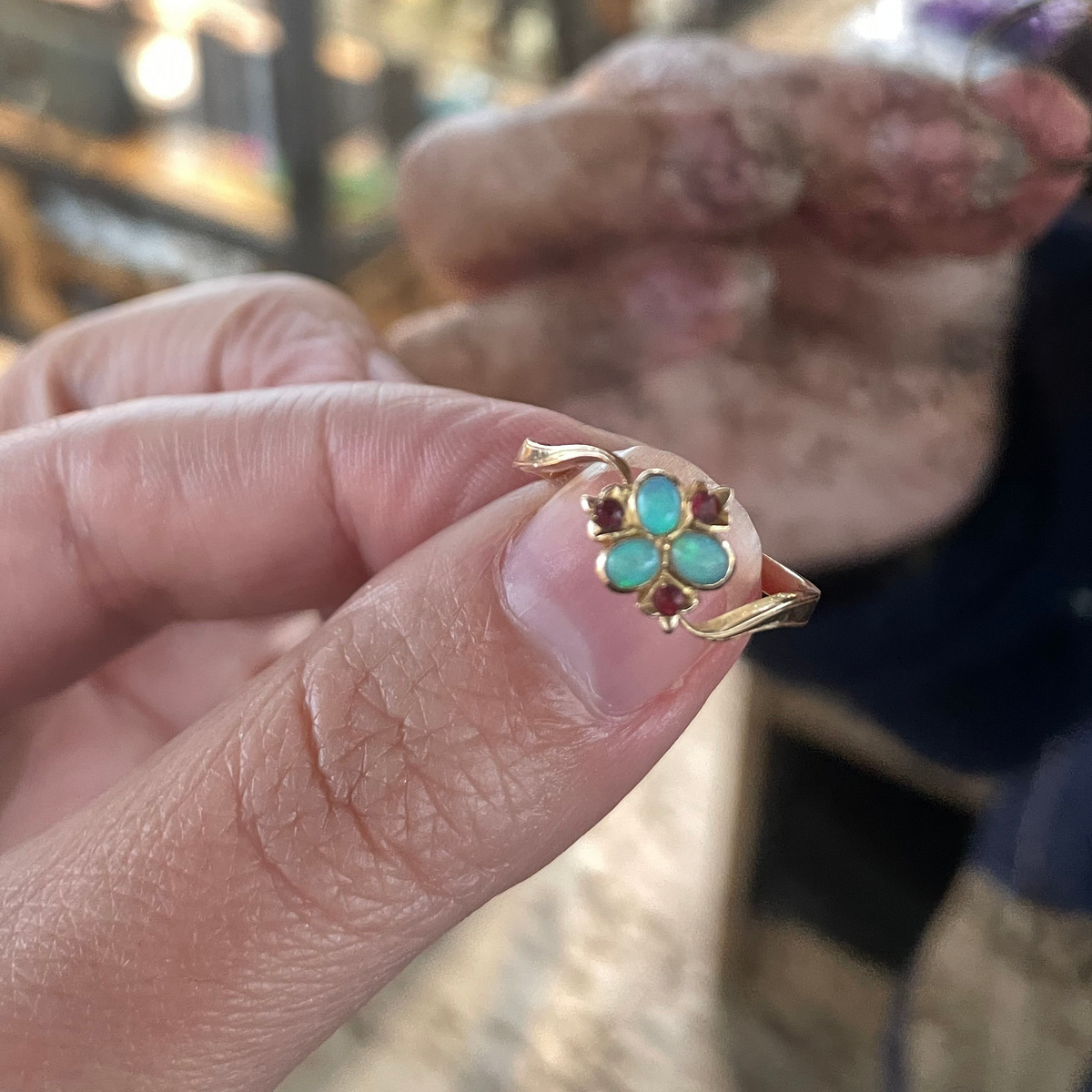 Opal flower ring set with vibrant opals and rubies, 18kt gold.