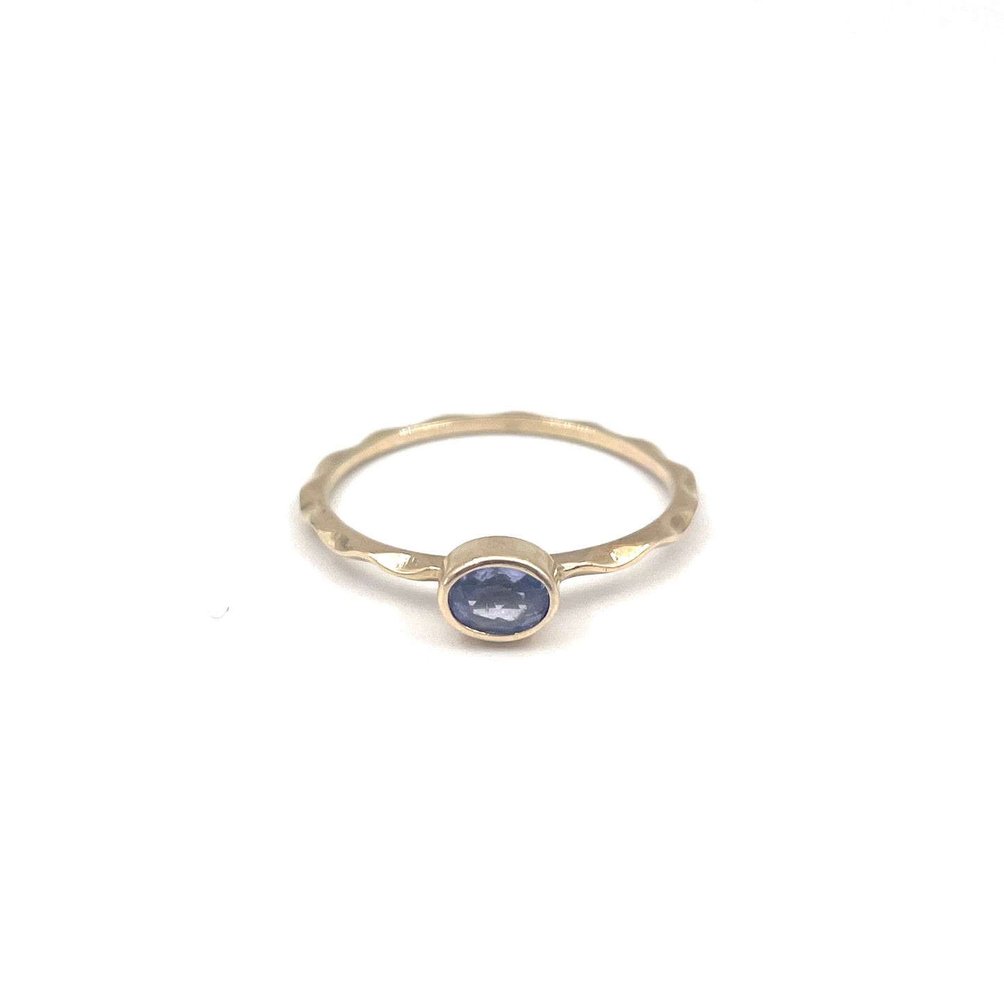 Tanzanite stacking ring on a 9kt wave band, preowned.