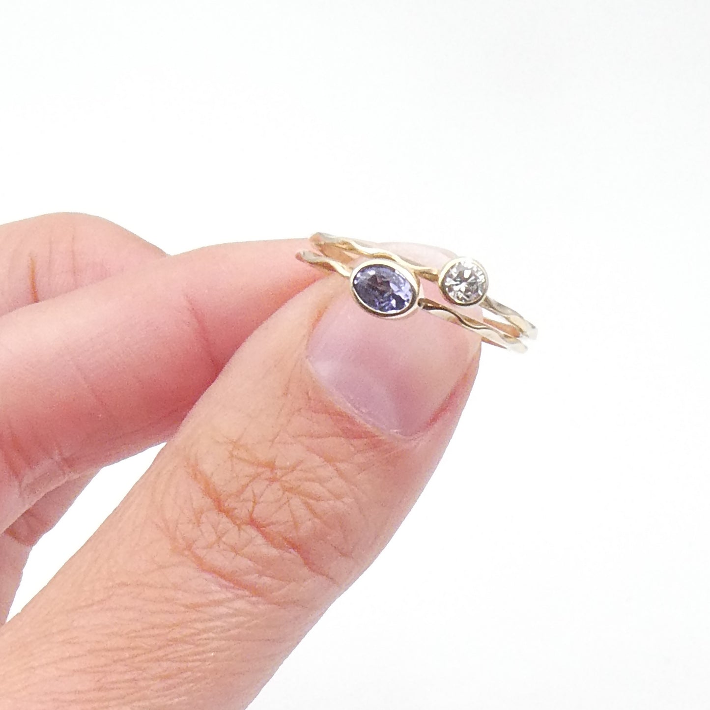 Tanzanite stacking ring on a 9kt wave band, preowned.