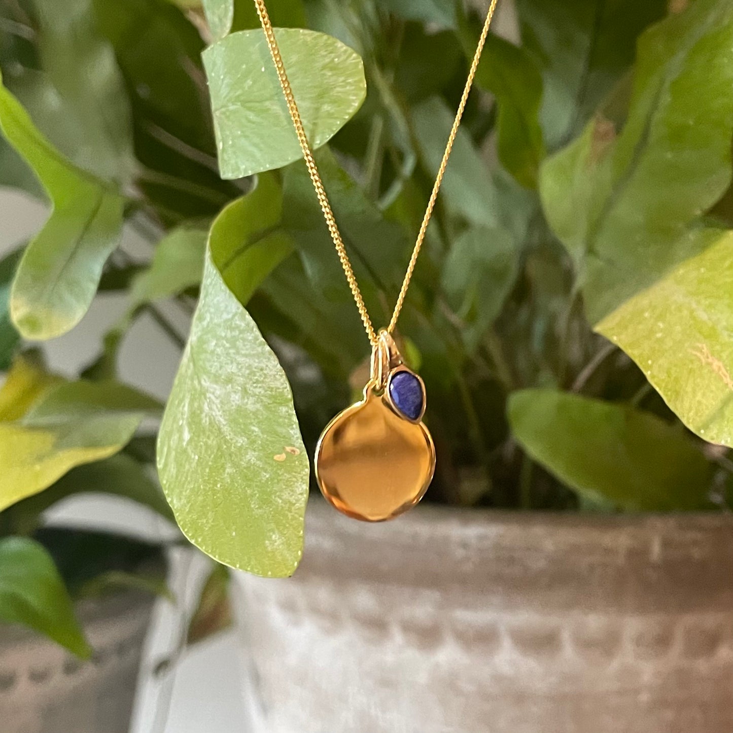 Gold Disc pendant with a lapis lazuli charm for an September Birthday.