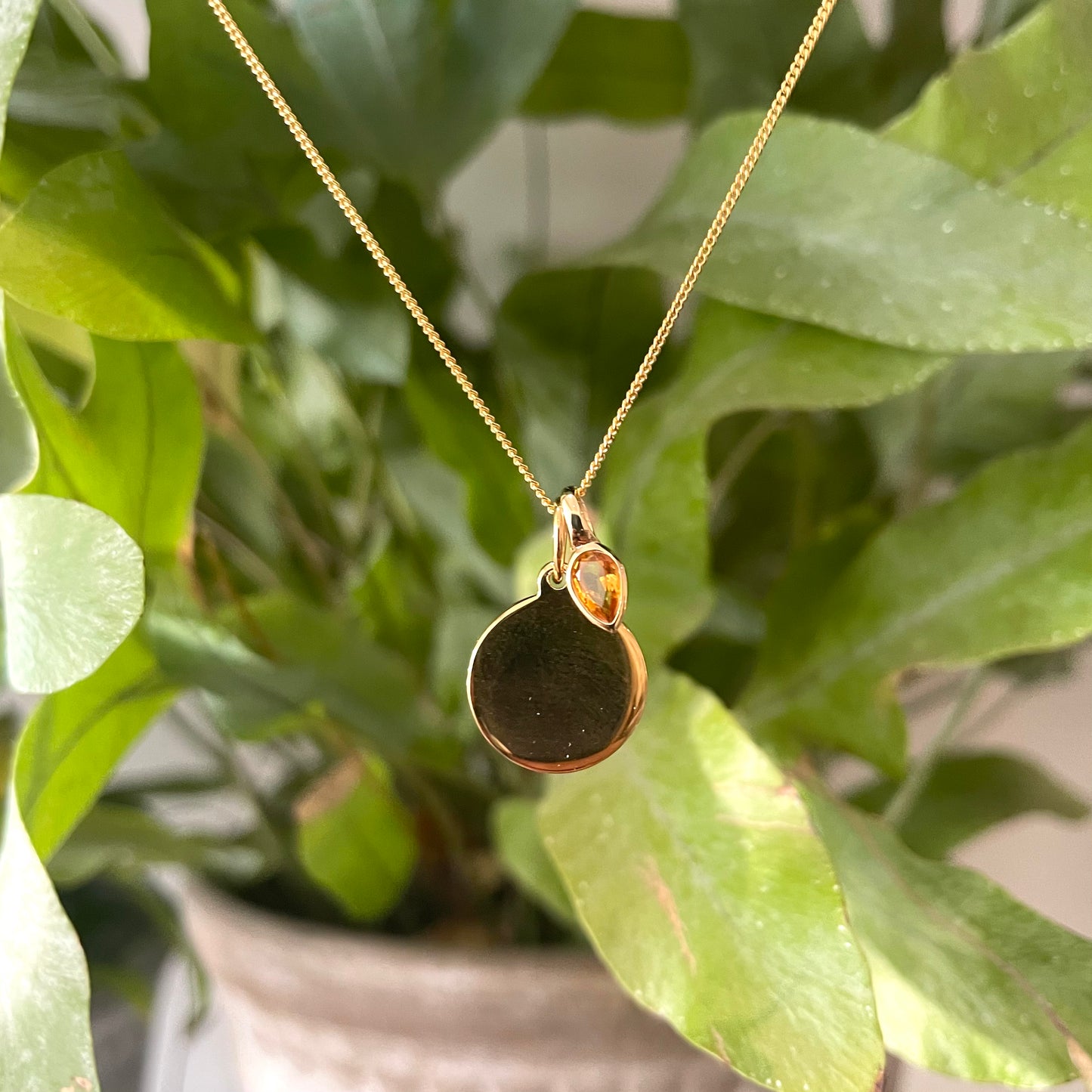 Gold disc pendant with a citrine charm for a November's Birthday.