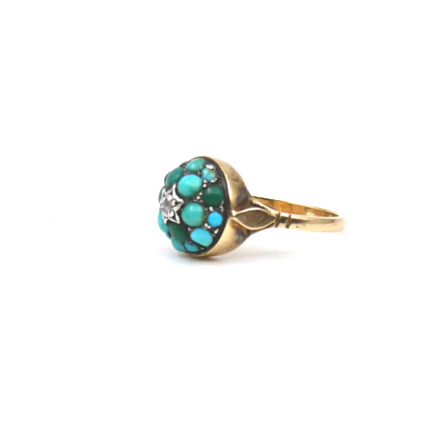 An antique turquoise bombe ring set with a star in the centre with a little diamond.