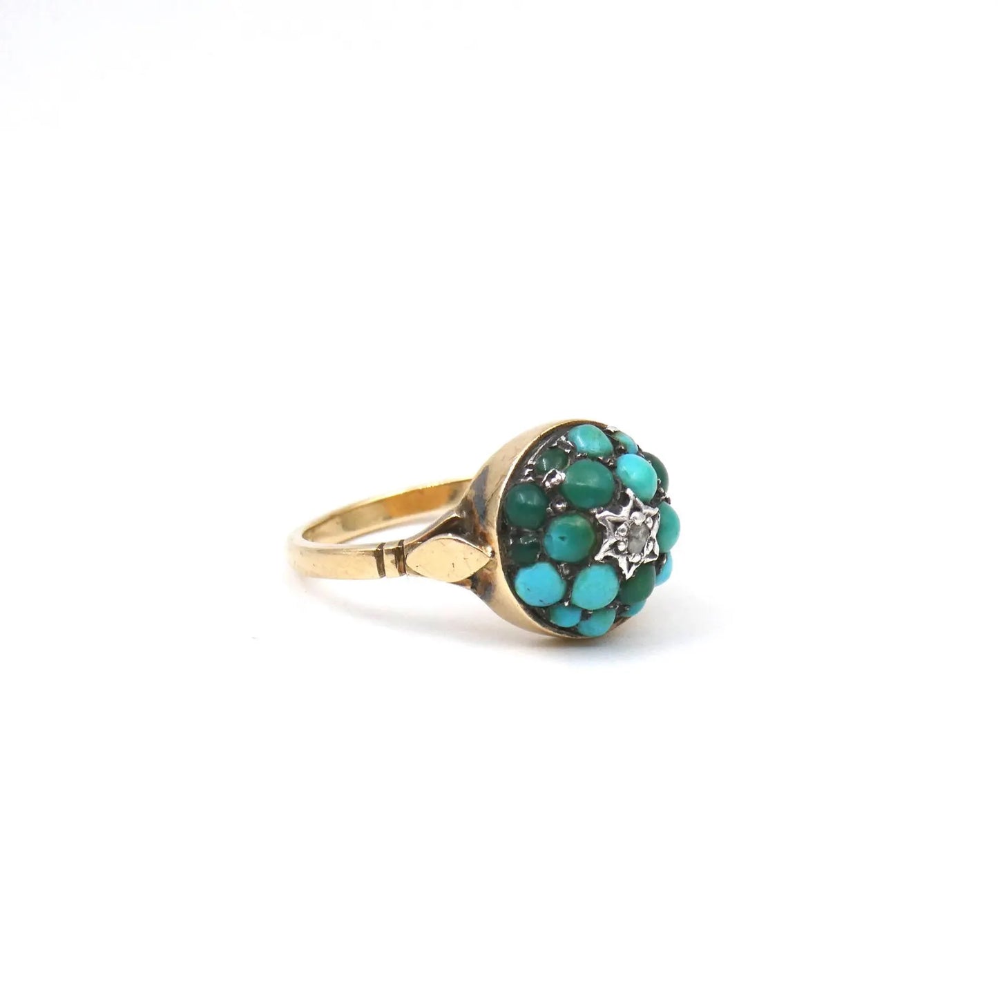 An antique turquoise bombe ring set with a star in the centre with a little diamond.