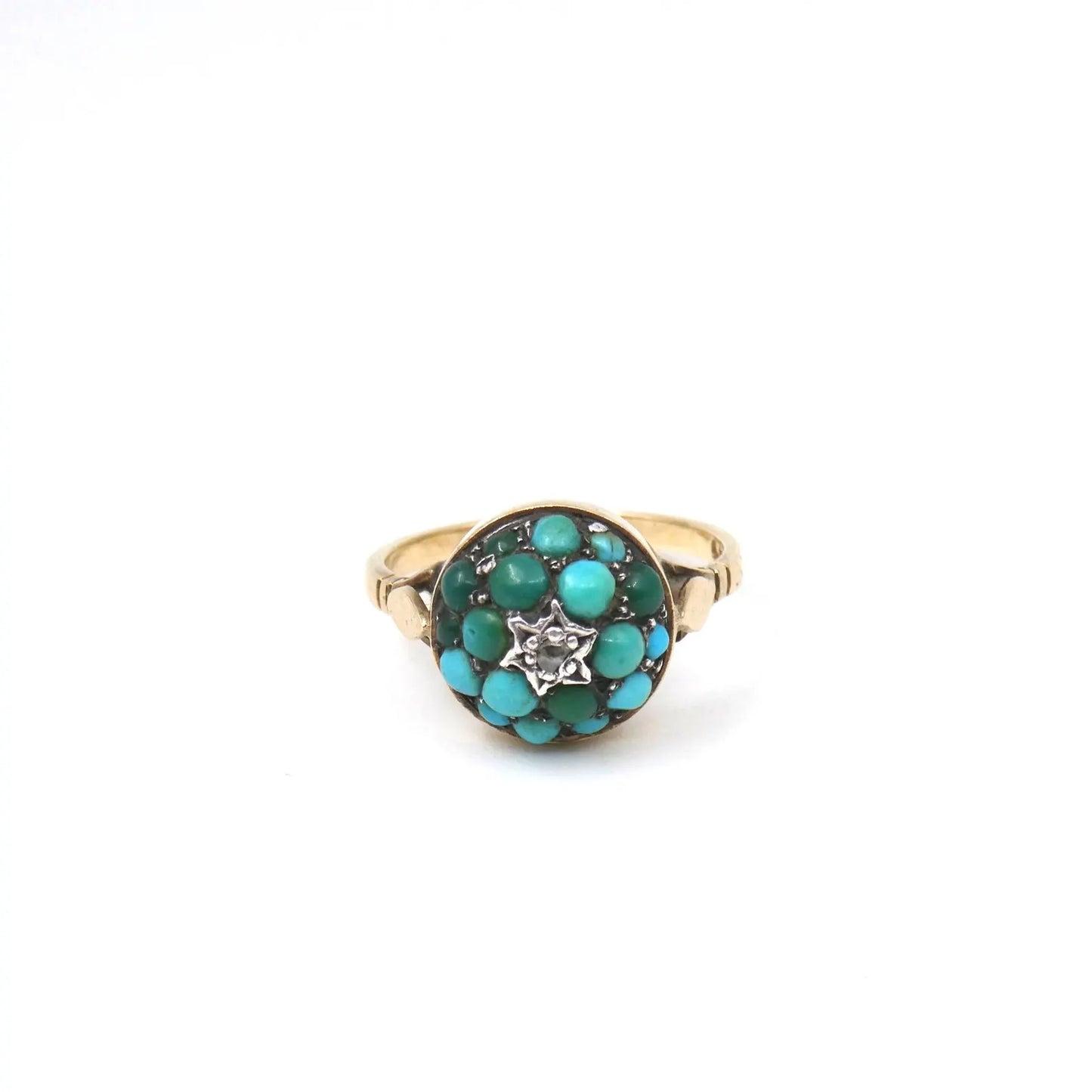 An antique turquoise bombe ring set with a star in the centre with a little diamond.