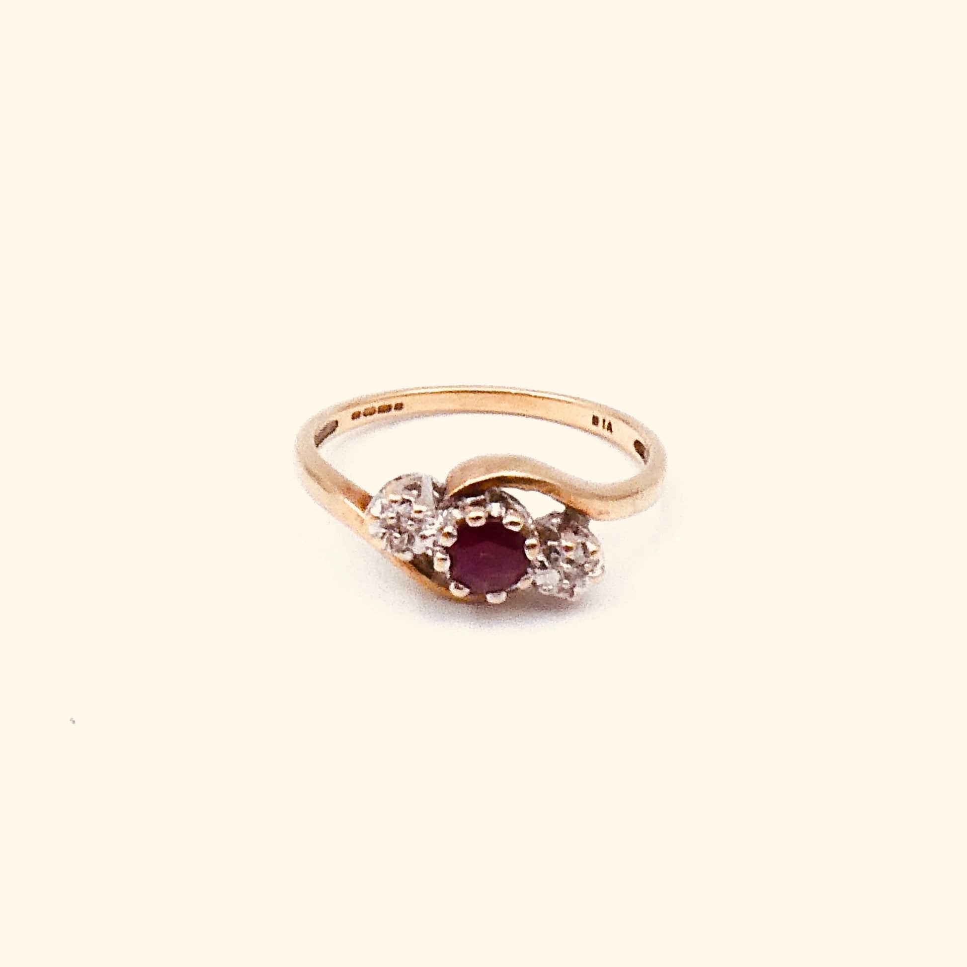 Vintage ruby and diamond ring, a classic three stone ring with a curved 9kt gold band. - Collected