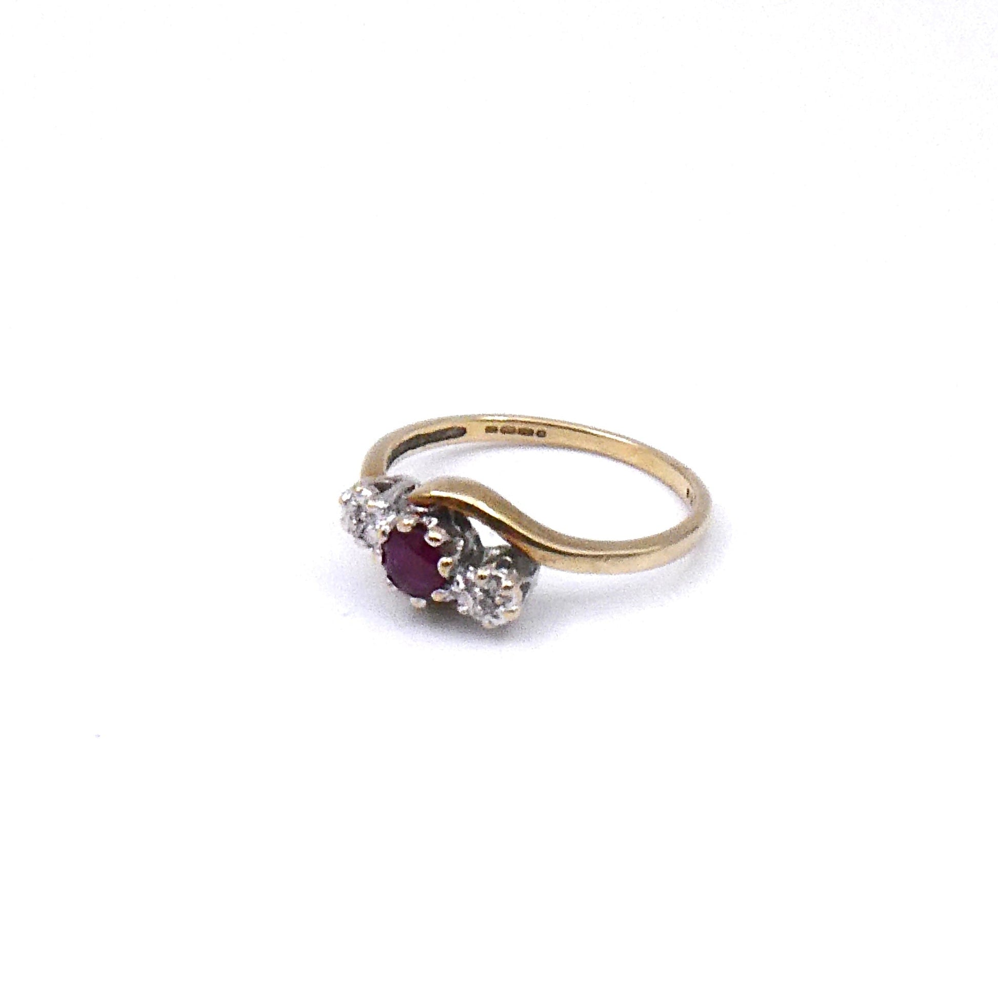 Vintage ruby and diamond ring, a classic three stone ring with a curved 9kt gold band. - Collected