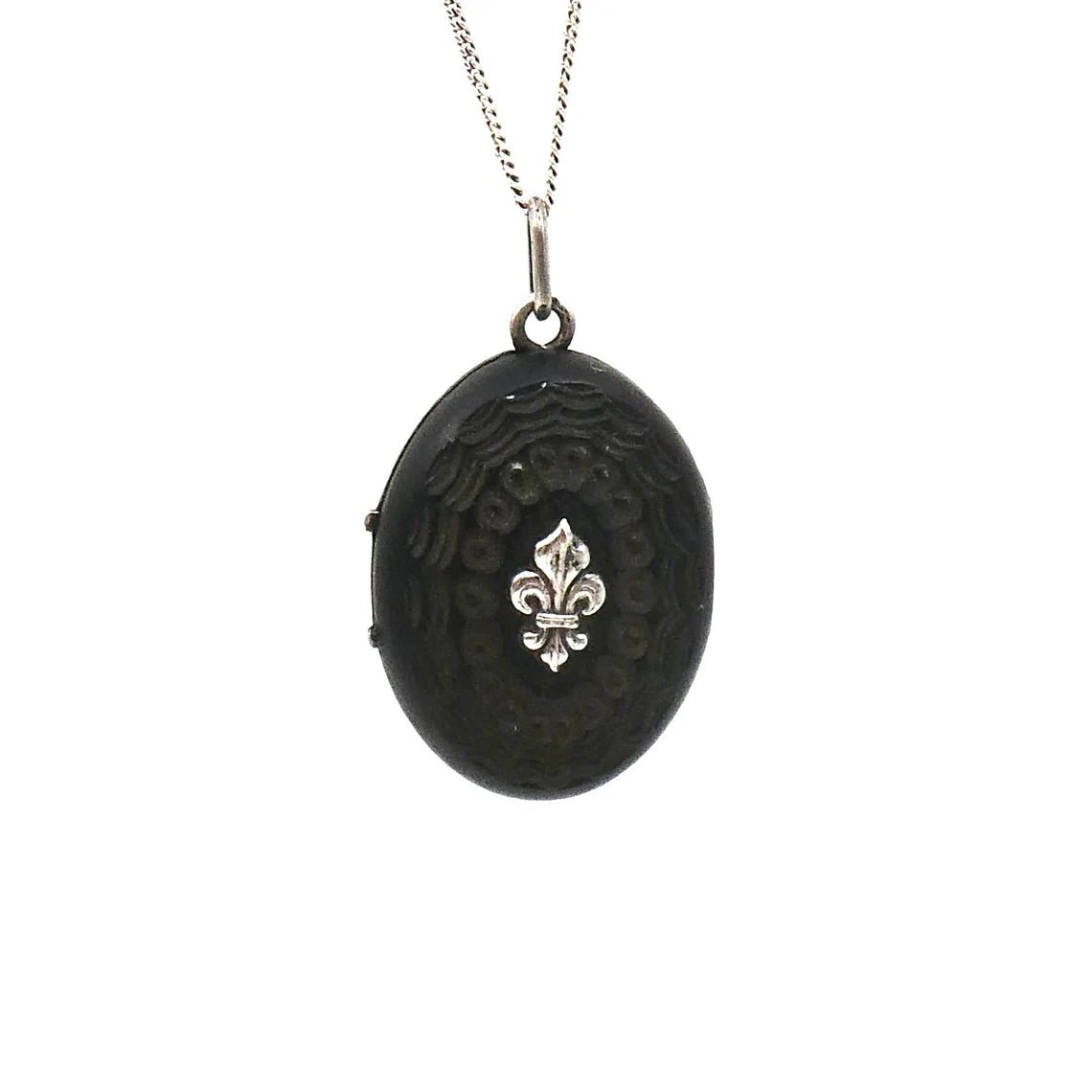 A unique carved black wooden locket with silver fleur de lis and initals in relief. - Collected