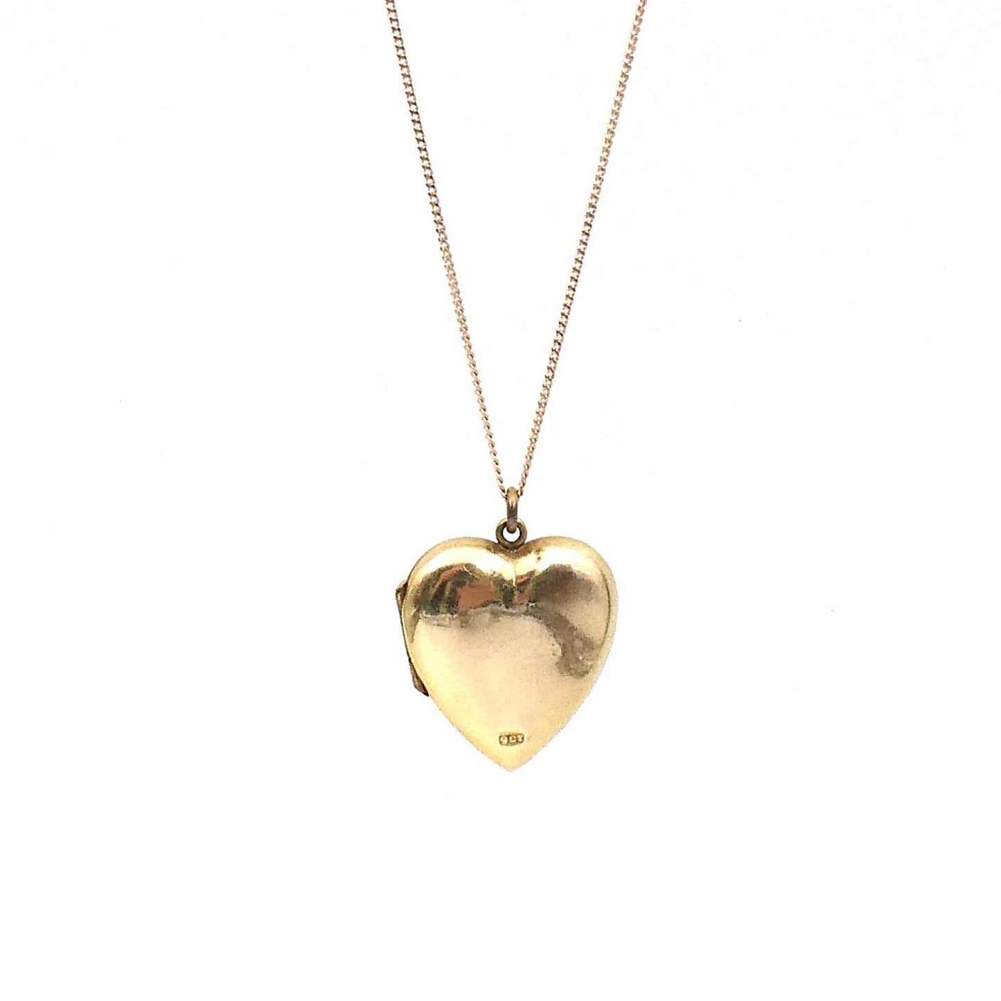 A vintage heart locket that opens to the side, with a foliate spray etched on the front. - Collected