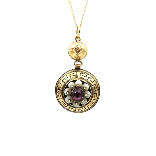 Antique pendant with an Etruscan pattern and a garnet gemstone surrounded by glass beads. - Collected