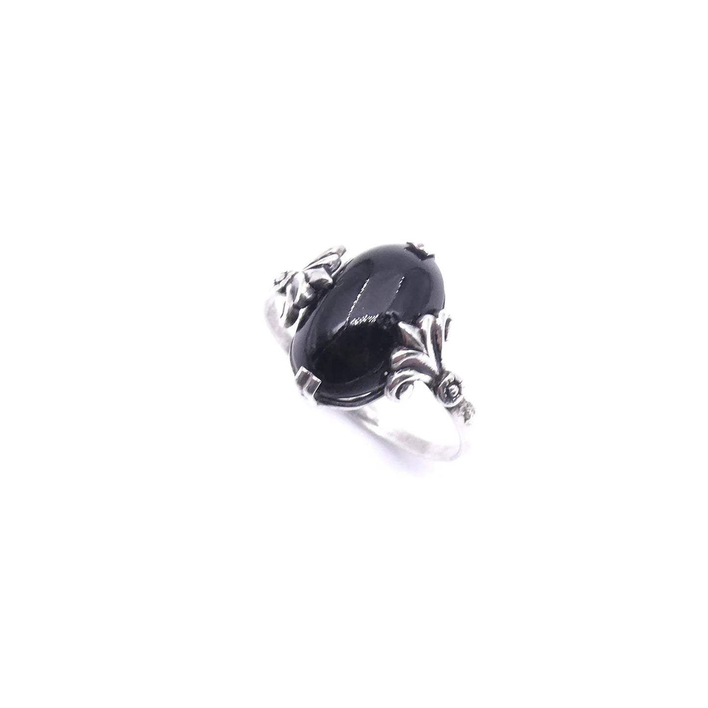 Antique style onyx and silver ring, with a scrolled silver setting. - Collected