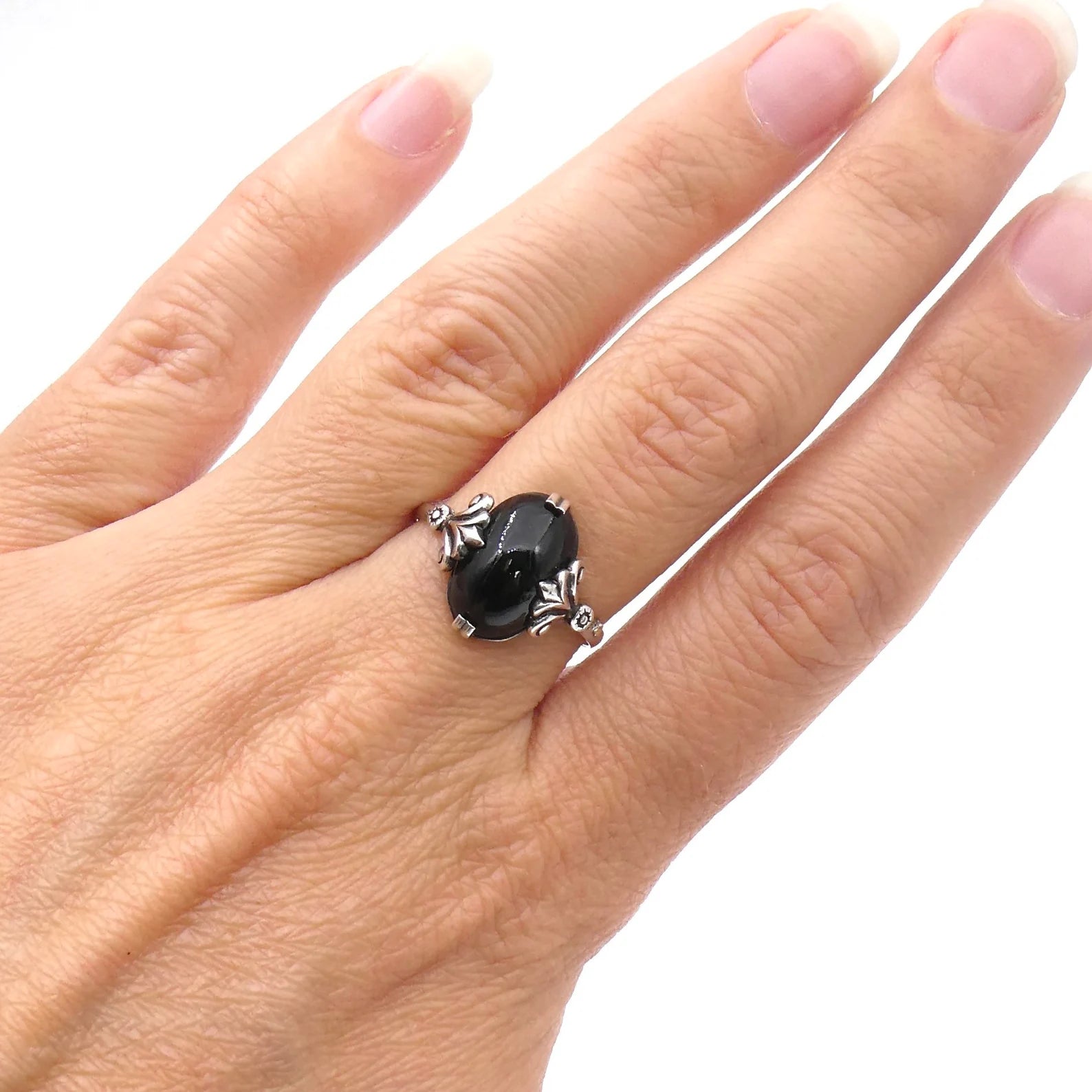 Antique style onyx and silver ring, with a scrolled silver setting. - Collected