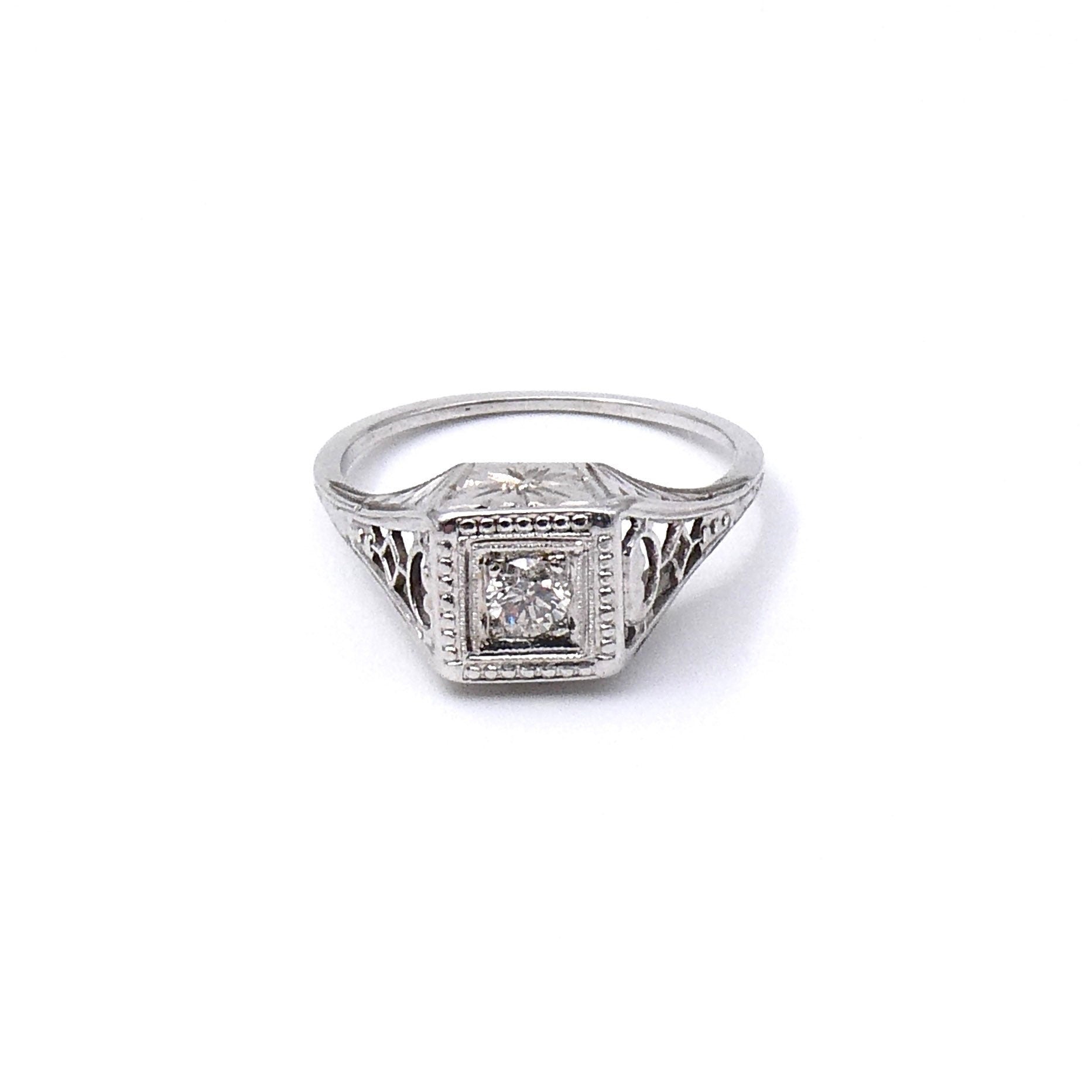 Art Deco diamond ring with a diamond and an ornate engraved setting that sits high on the finger. - Collected