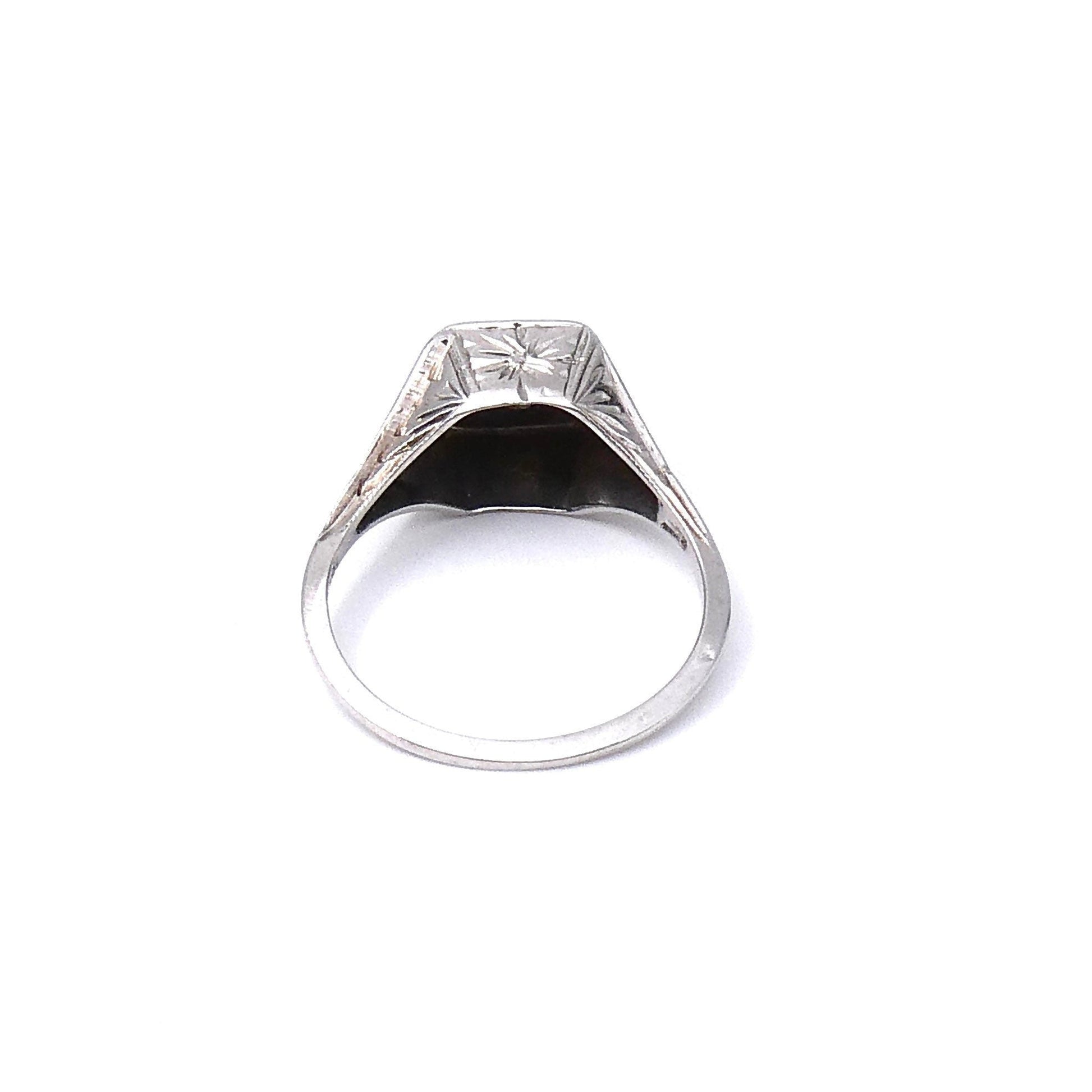 Art Deco diamond ring with a diamond and an ornate engraved setting that sits high on the finger. - Collected