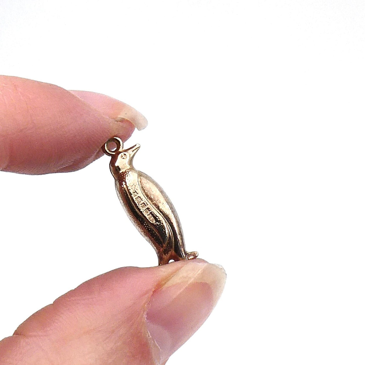 Vintage gold penguin pendant, a quirky vintage piece on a chain.