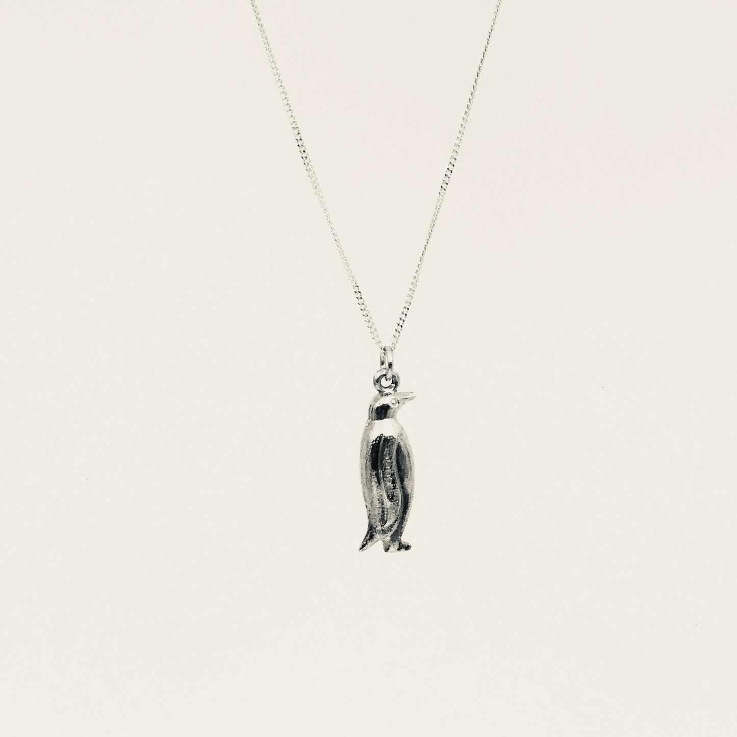 Vintage gold penguin pendant, a quirky vintage piece on a chain.