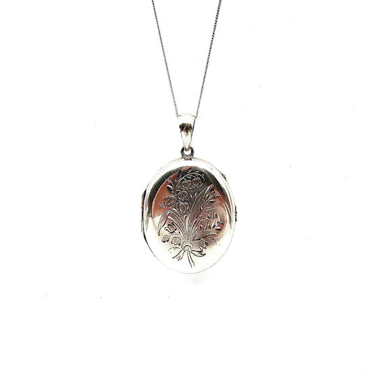Vintage silver locket with an etched floral and leaf bouquet design. - Collected