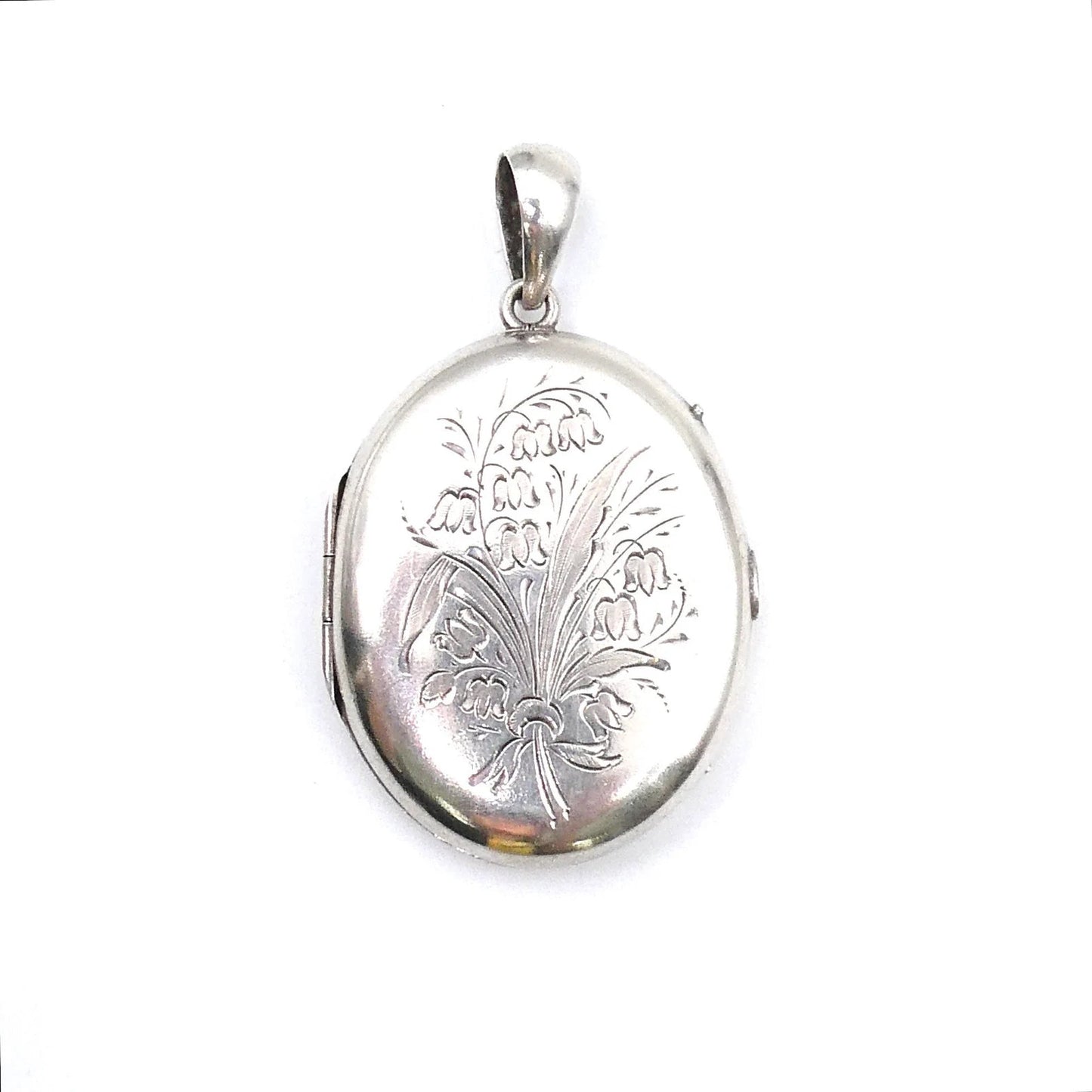 Vintage silver locket with an etched floral and leaf bouquet design. - Collected